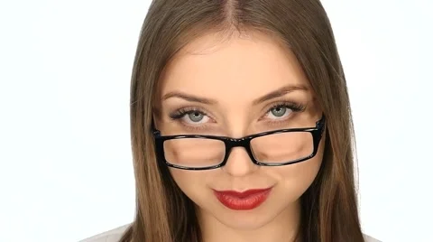 The girl in  glasses posing on a white background,slow motion Stock Footage 63483842