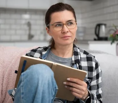 Girl In Glasses Writing Notes In Notebook Фото
