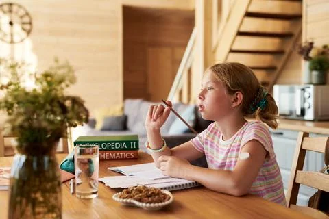 Girl with Glucose Sensor Studying at Home and Doing Homework Stock Photos