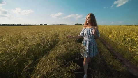 Girl goes on a rural road. Stock Footage