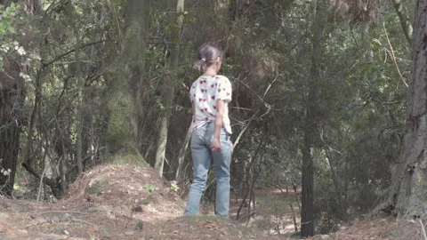 Girl going down a slope in the forest Video stock 137686168