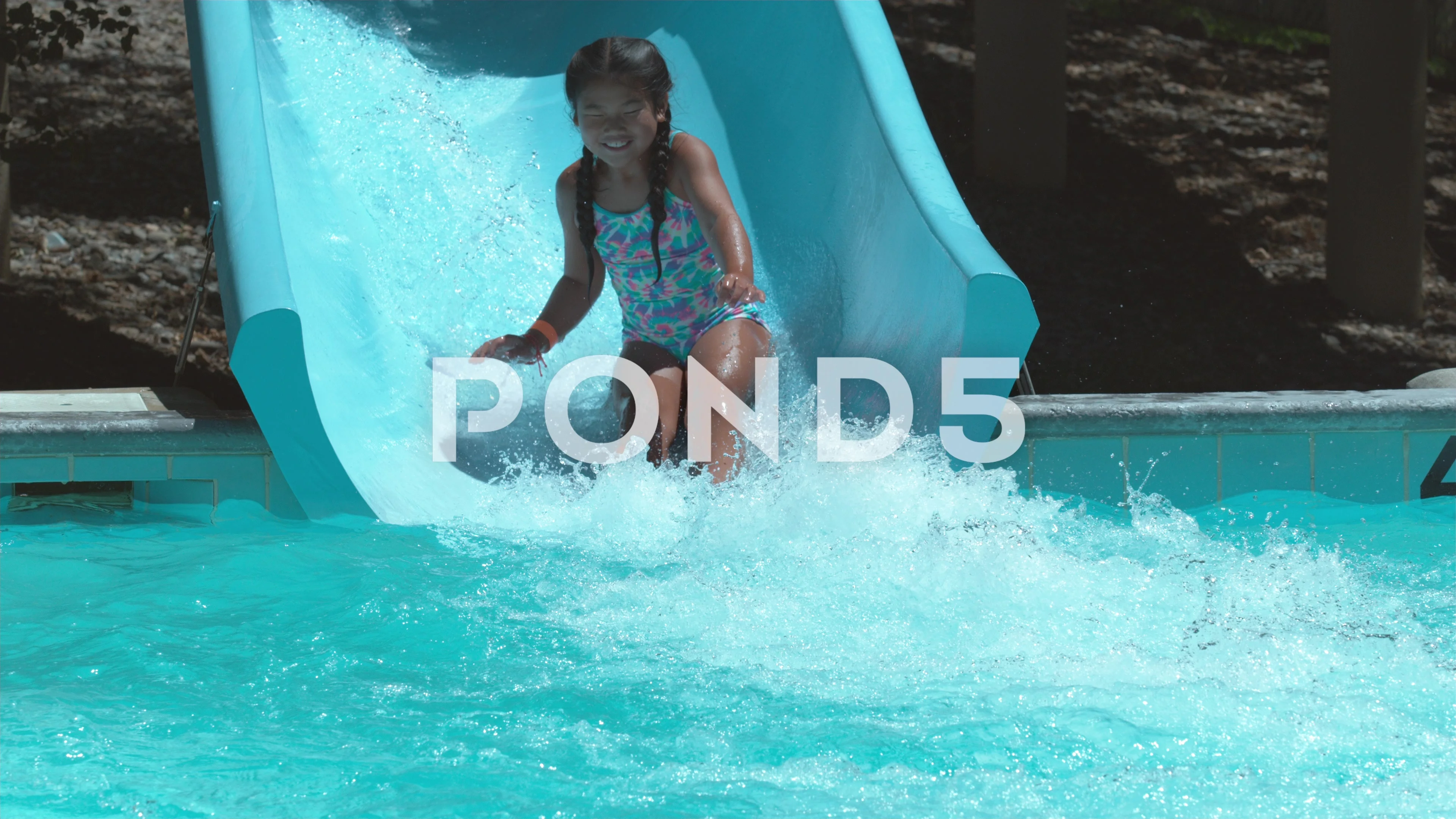 Girl going down waterslide in super slow motion