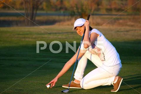 Girl golf player preparing for shot Stock Photos