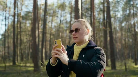 The girl got lost in the forest and is looking for a mobile connection Stock Footage 191945763
