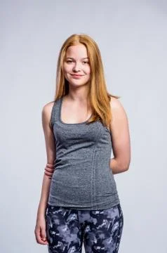Girl in gray singlet and fitness leggings, studio shot Stock Photos