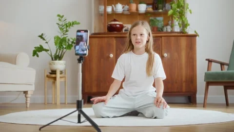 Girl greets audience while recording vlog on smartphone Stock Footage 312288712
