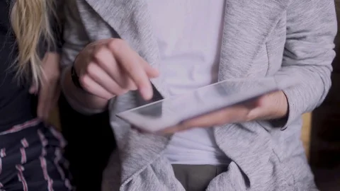 Girl with a guy in a cafe found in the tablet something funny Vídeo Stock 79848642