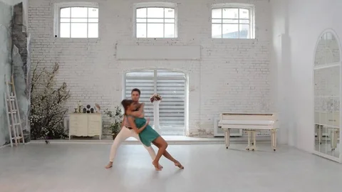 Girl with guy dance gymnastic dance in the dance hall Stock Footage