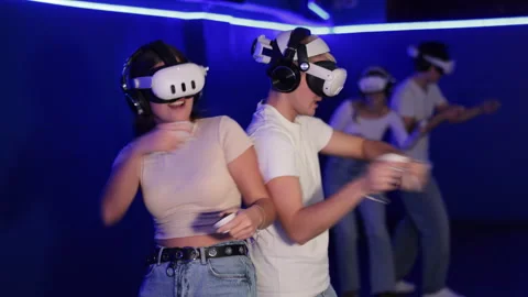 Girl with guy pair wearing virtual reality glasses participate in game with Stock Footage 314764940