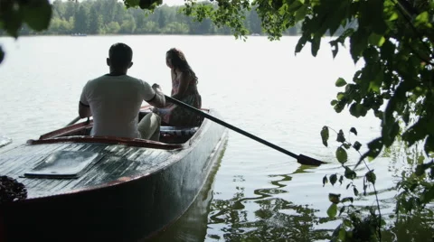The girl with the Guy Sailing down the River on an Iron Boat Stock Footage 68084323