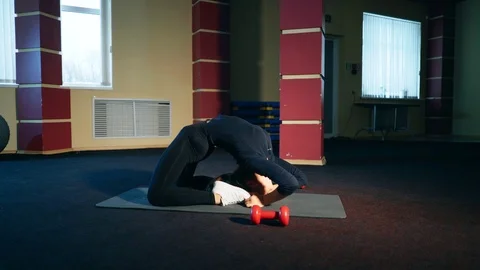 Girl in the gym performs an exercise bridge. Stock Footage 103980484