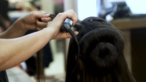 Girl Hair style or Straighten hair by Professionals using iron Stock Footage