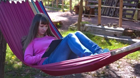 Girl on hammock with tablet pc Stock Footage 72921534