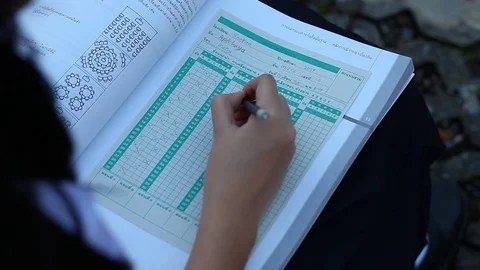 The Girl hand is filling a blank on answer paper with pencil Stock Footage