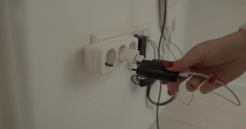 A girl hand that puts something loaded into the socket. Stock Footage 127849314