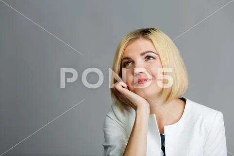 Girl with hand under chin Stock Photos