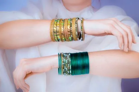 Girl hands with golden bracelets Stock Photos