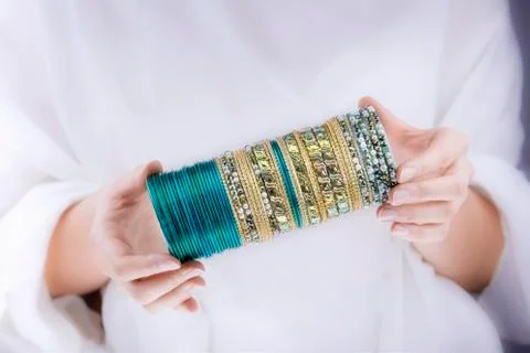 Girl hands with golden bracelets Stock Photos