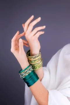 Girl hands with golden bracelets Stock Photos