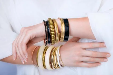 Girl hands with golden bracelets Stock Photos