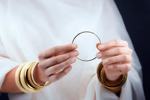 Girl hands with golden bracelets Stock Photos