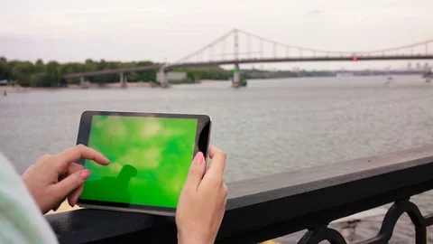 Girl hands holding tablet device with green screen touchscreen. Finger scrolling Stock Footage 74481629