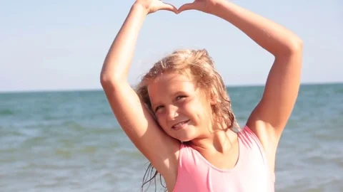 Girl hands on the sea heart Stock Footage