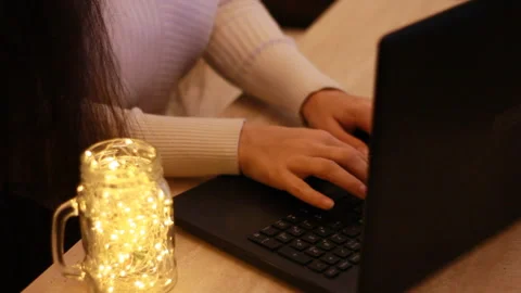 Girl hands using computer laptop on desk at home interior. Background with bokeh Stock Footage 95969901