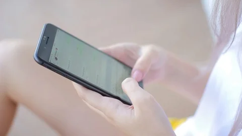 Girl hands using smartphone typing an sms message to his friends Video stock 94419524