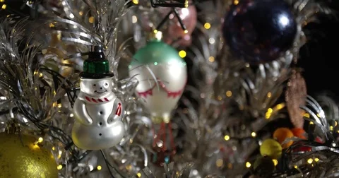 Girl Hanging Christmas Ornaments on Aluminum Christmas Tree (Sequence) Stock Footage