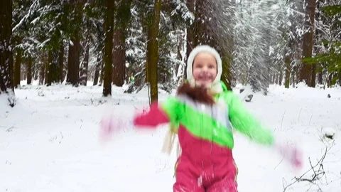 Girl has fun in the winter, throwing a handful of snow up in the air Stock Footage 85217880