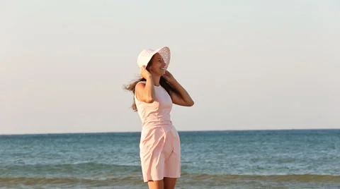 Girl in hat on the beach Stock Footage 67825829