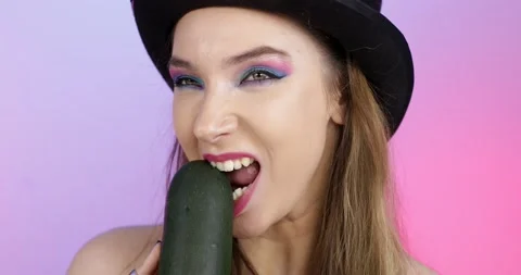 The girl in the hat eats green zucchini. Stock Footage 166739505