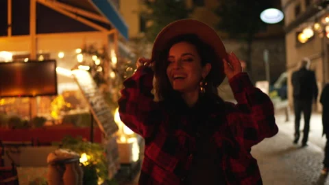 Girl with a hat having fun on the evening street Stock Footage 169636511