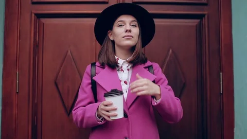 Girl in a hat smiling and drinking coffee Video stock 71127136