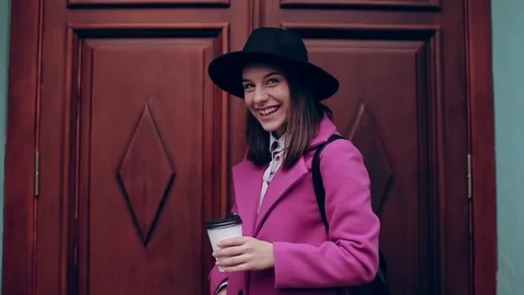 Girl in a hat smiling and drinking coffee 動画素材 71127139