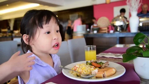 Girl having breakfast on the table Stock Footage 75531684