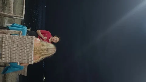 A Girl having dinner under the sky, at night on the beach. Waitress taking order Video stock 280436202