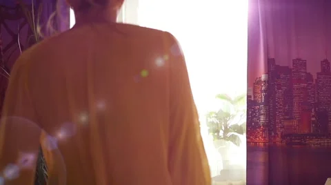 Girl having fun dancing at the window in the sunlight 库存影片 68717174