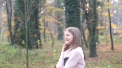 Girl having fun throwing leaves in the air Stock Footage 59553832