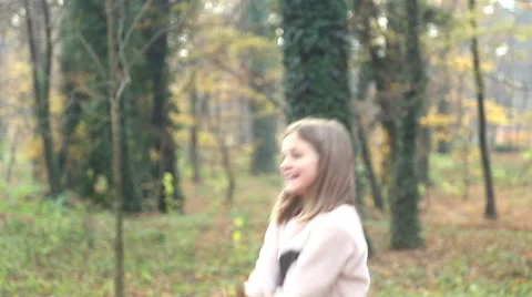 Girl having fun throwing leaves in the air Stock Footage 59553836