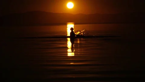 Girl having fun in the water in the rays of the setting sun Stock Footage 138874789
