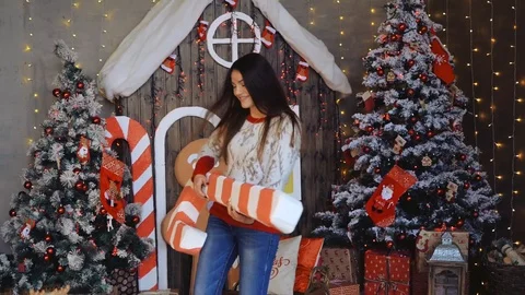Girl is having fun while playing on candy cane like it could be a guitar. Video stock 98575416