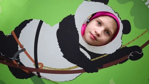 Girl of head in the hole instead of the muzzle of the panda climber Stock Footage 73727824