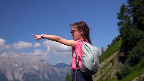 Girl hiking on beautiful summer day in alps mountains Austria Stock Footage