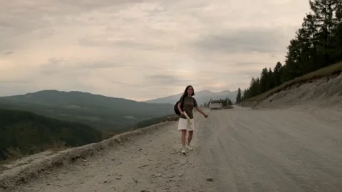 The girl is hitchhiking alone. Stock Footage
