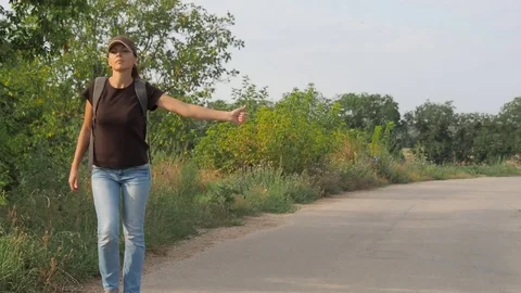 The girl is hitchhiking. Stock Footage