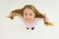 The girl hold her hair and smile. View from above Photo
