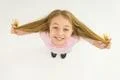 The girl hold her hair and smile. View from above Photo