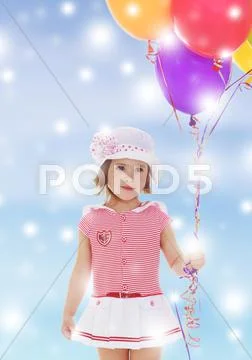 Girl holding balloons Stock Photos